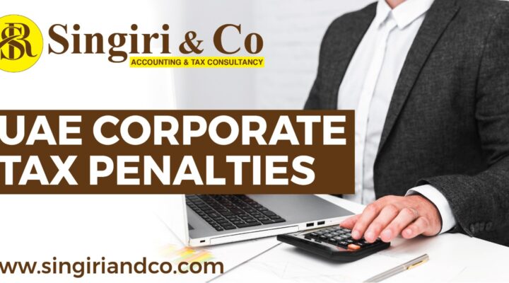 A man using a laptop and calculating the accounts to keep updated about corporate tax penalties.